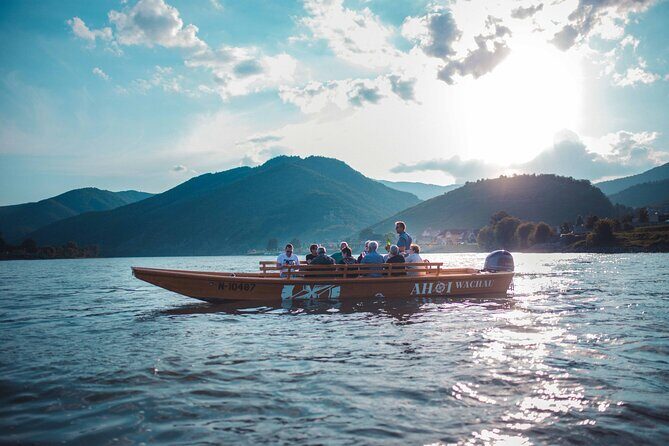 Wine tasting on traditional wooden boats in Wachau Valley - Dürnstein sights from the water: castle, abbey, and the ruin